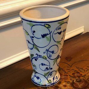 Ceramic cream colored vase with blue vine and orange and yellow flowers